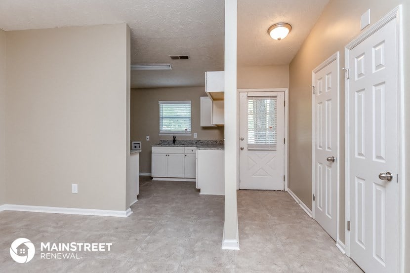 the kitchen is open to the living room and laundry room
