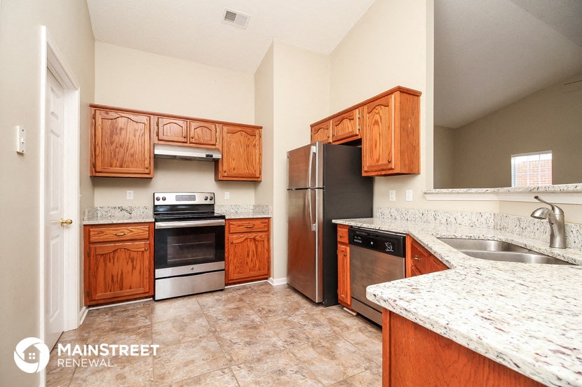 a kitchen with wooden cabinets and stainless steel appliances
