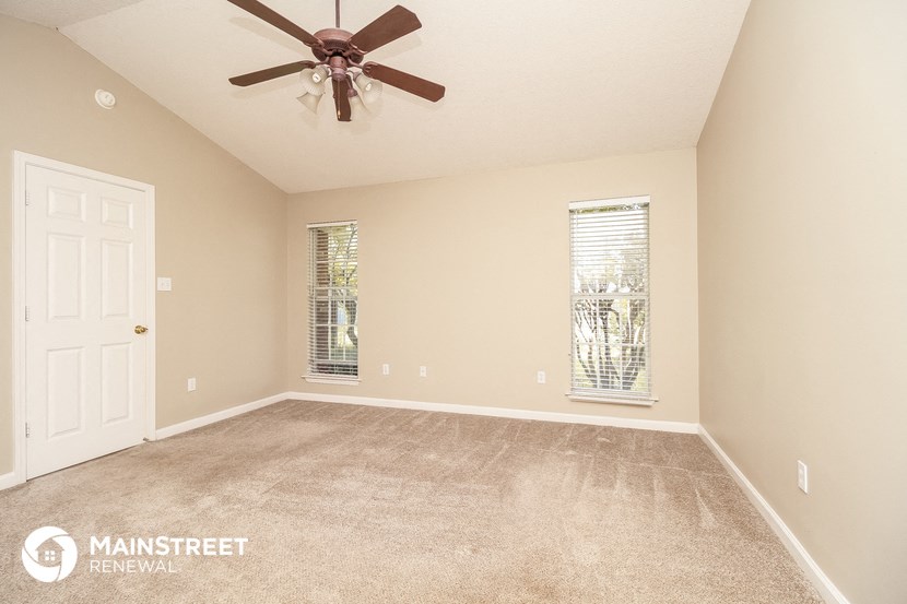 the master bedroom is spacious and has a ceiling fan