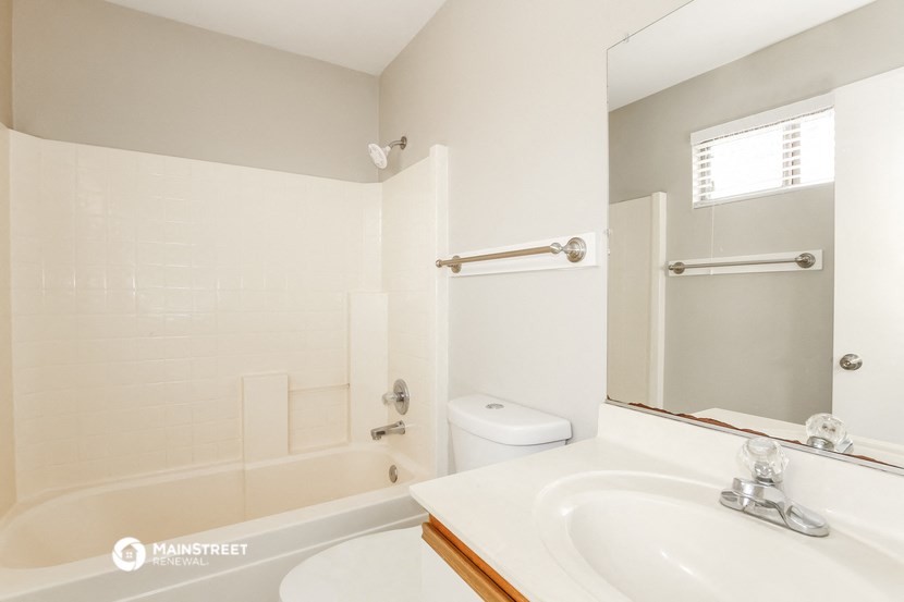 a bathroom with a sink and a bath tub and a mirror