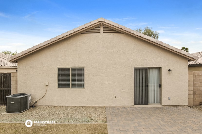 a single story house with a garage and a water heater