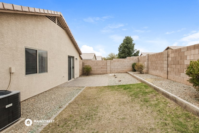 the backyard of a house with a yard and a fence