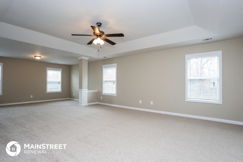 the master bedroom is spacious and has a ceiling fan