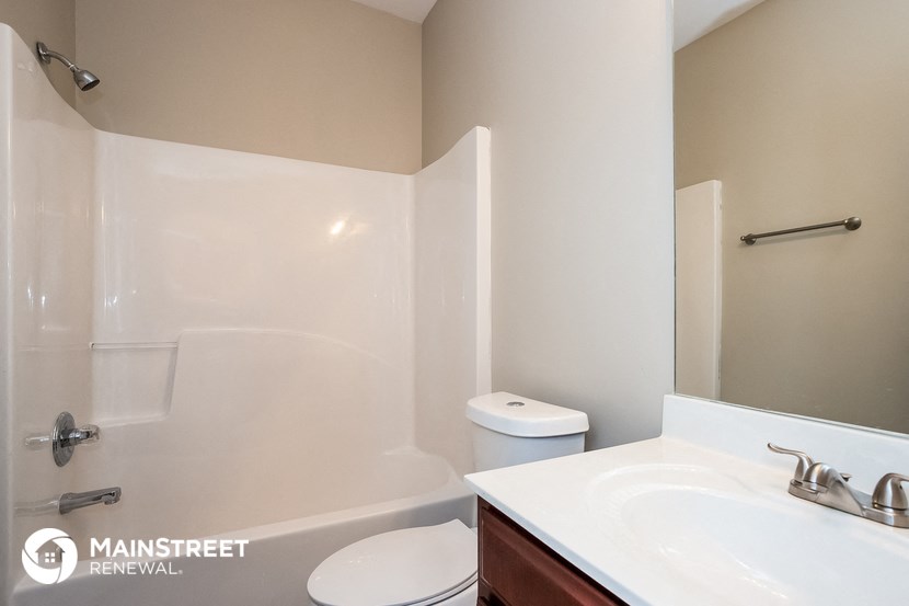 a bathroom with a sink and a toilet and a shower