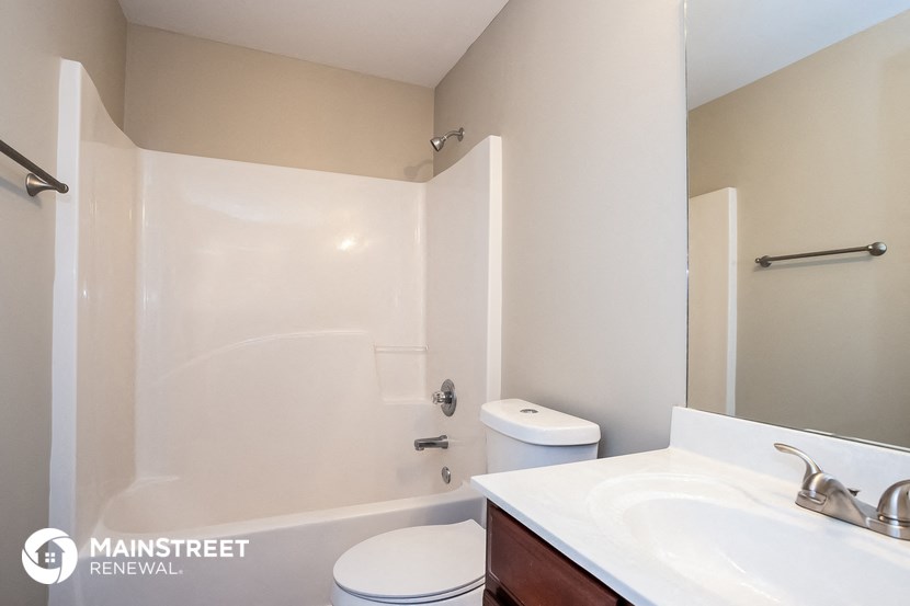 a bathroom with a sink and a toilet and a shower