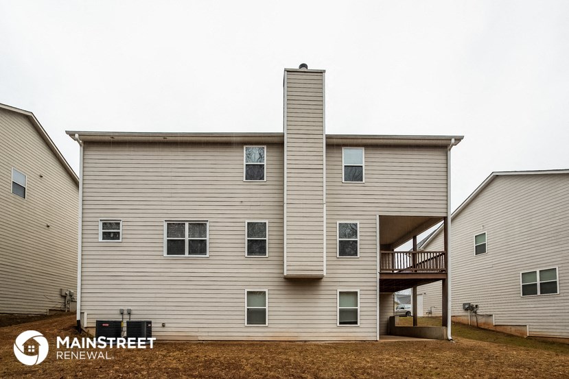 a white house with a chimney on the side of it