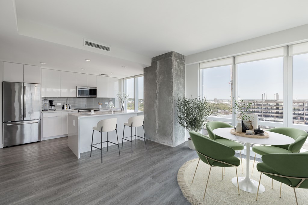 A modern kitchen with a dining table and chairs.