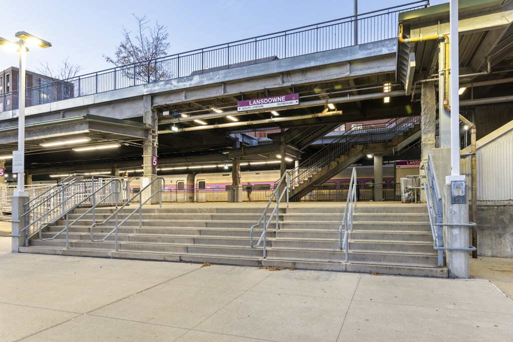 A parking garage with a staircase leading to the second level.