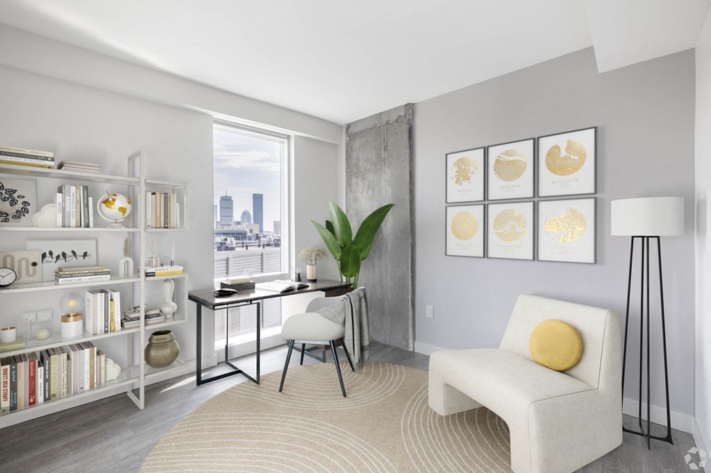 A living room with a white chair and a table with a plant on it.
