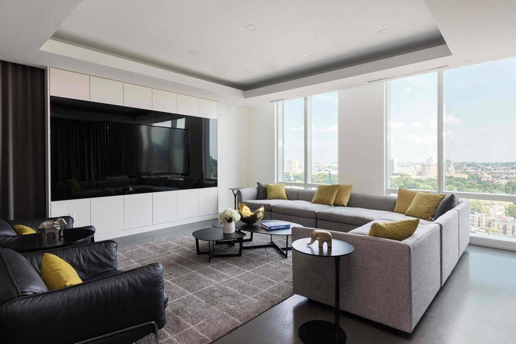 a living room in a high rise apartment with a couch and a television