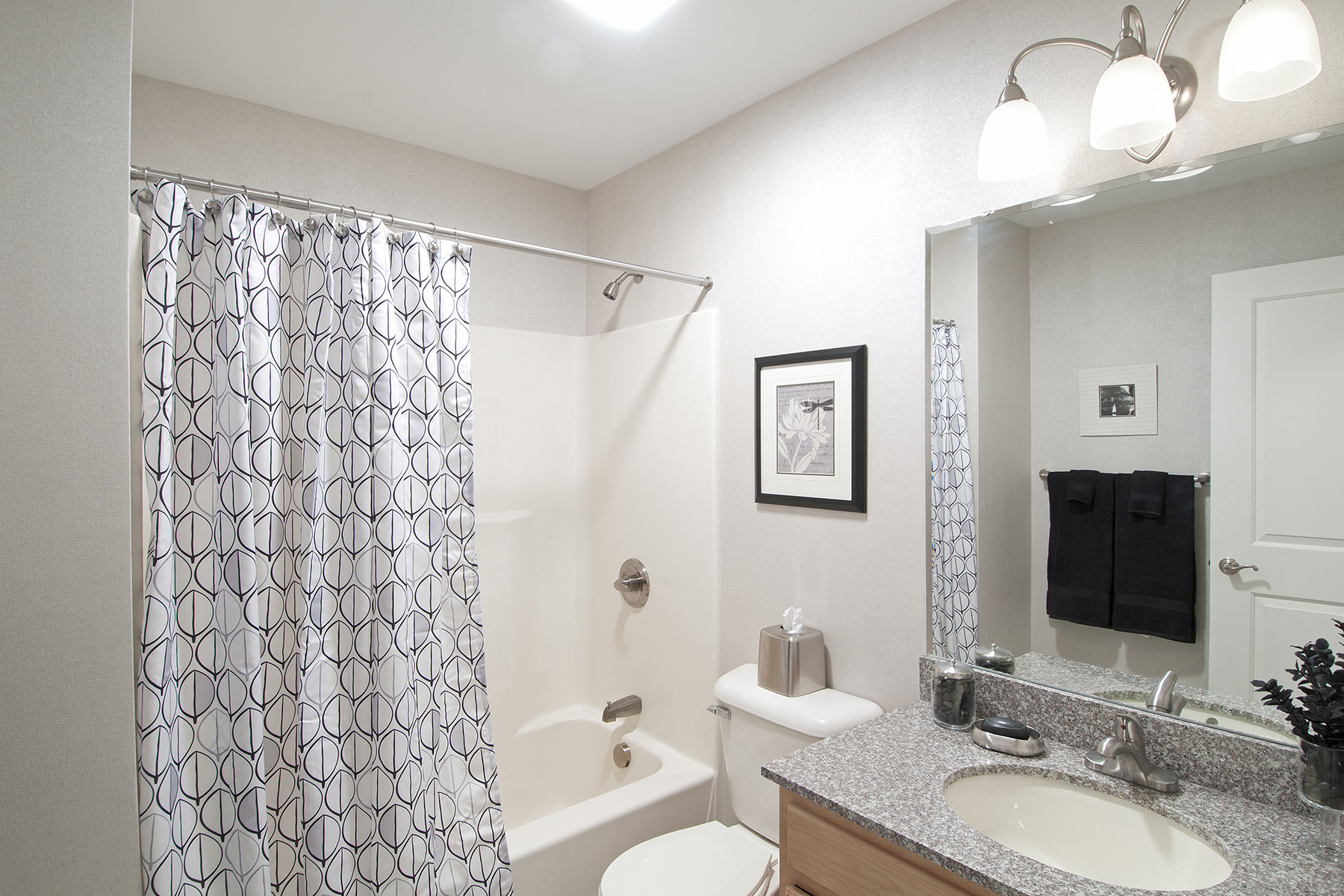 a bathroom with a shower and a sink and a toilet