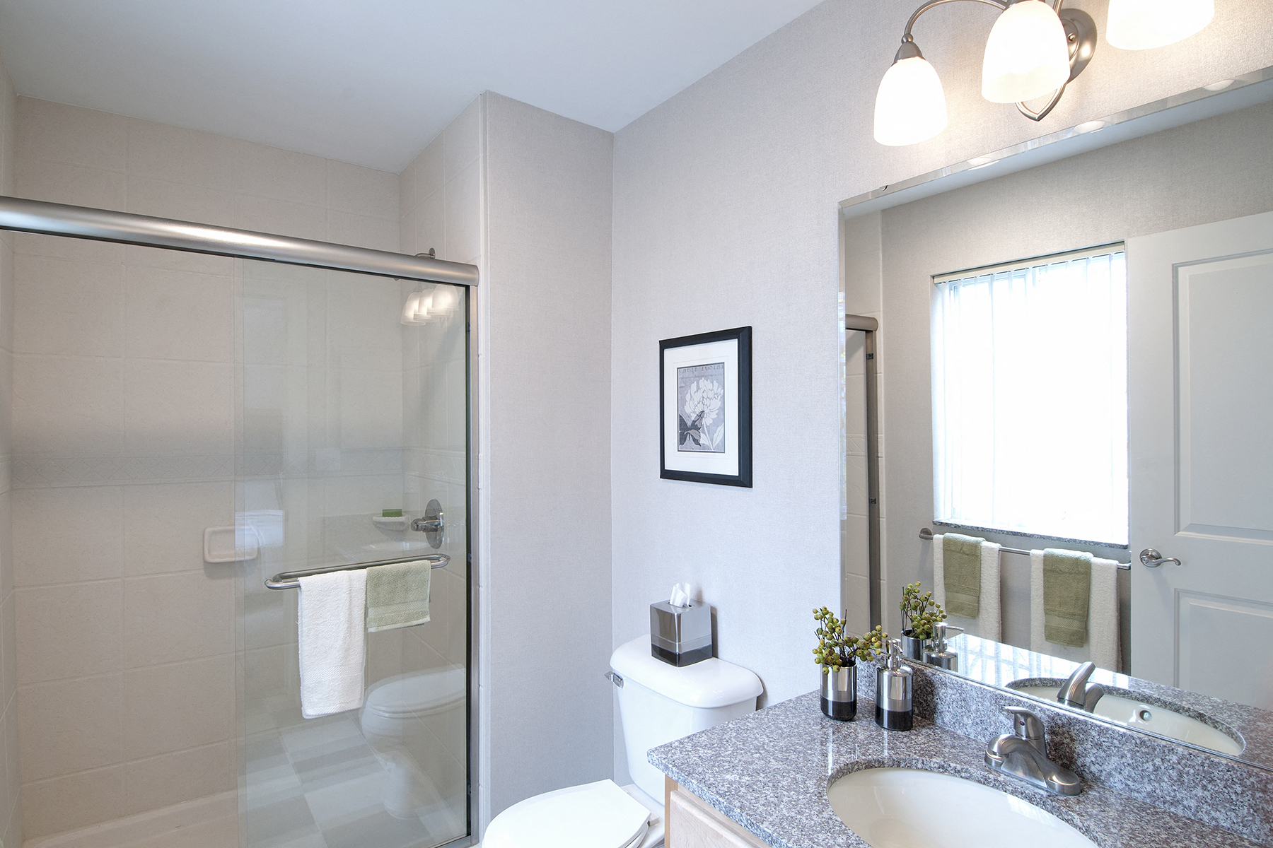 a bathroom with a shower and a sink and a toilet