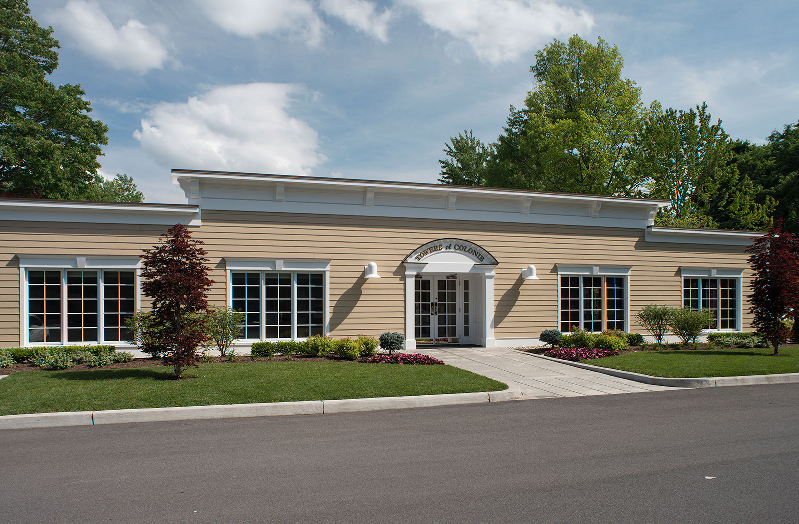 the front of a building with windows and a driveway