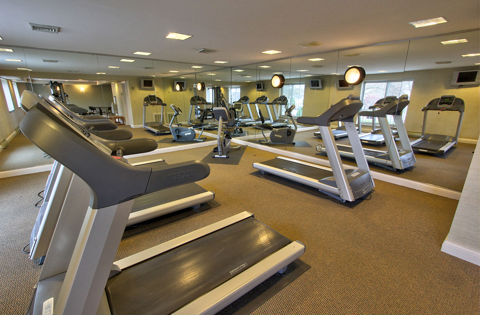 a gym with treadmills and other exercise equipment