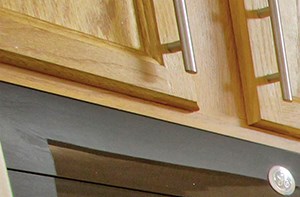 a kitchen with stainless steel appliances and wooden cabinets