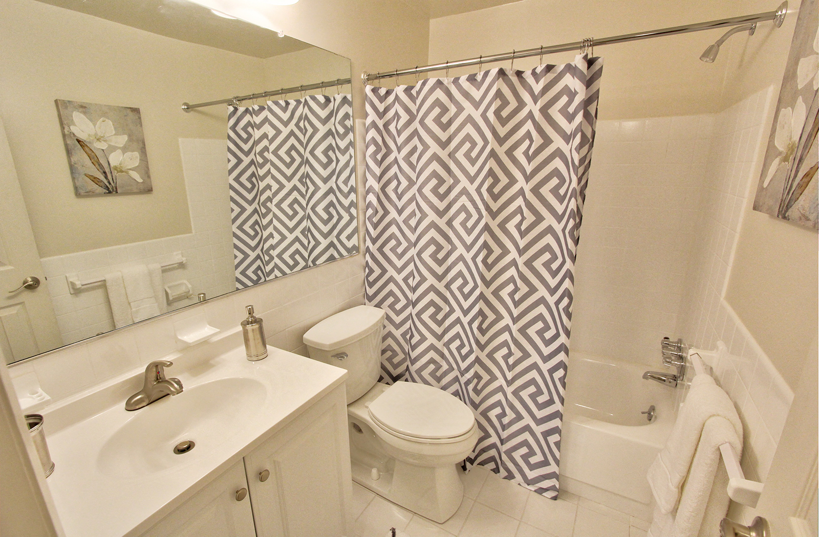a bathroom with a shower curtain and a toilet and a sink