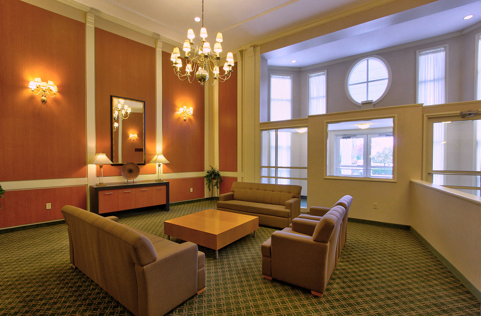 a living room with couches and chairs and a chandelier