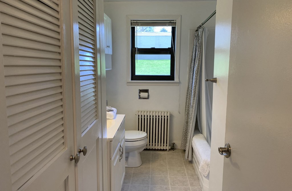 a small bathroom with a toilet and a window