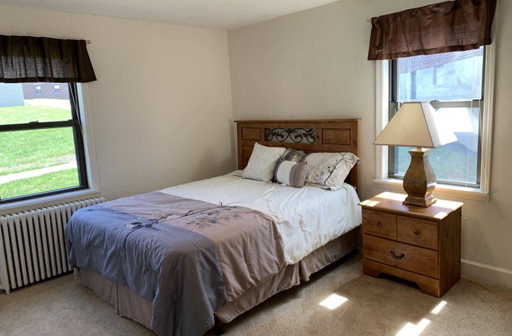 a bedroom with a bed and a window