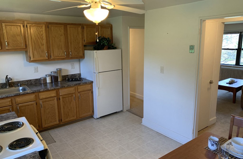 an empty kitchen with a refrigerator and a sink