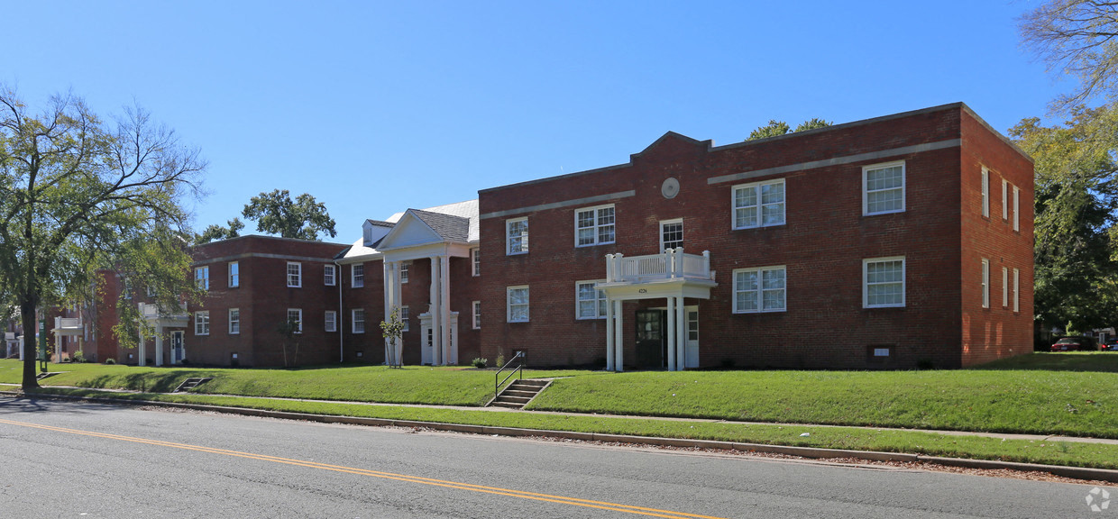 a large brick building on the side of a street