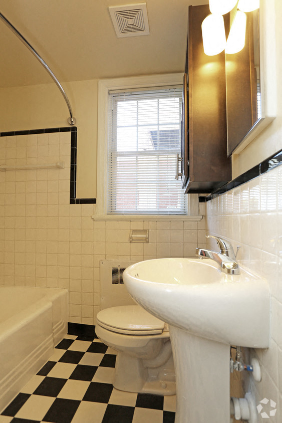 a white bathroom with a sink and a toilet