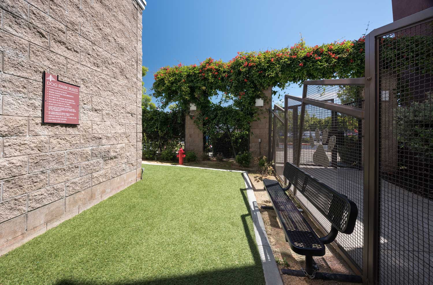 a courtyard with a bench and a gate