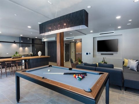 a pool table and a tv in a living room