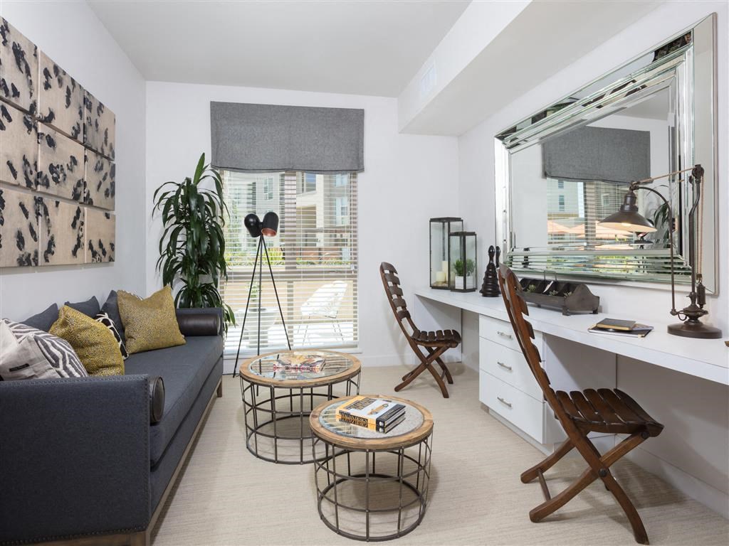 a living room with a couch and a desk