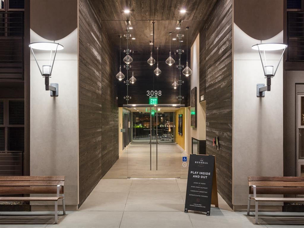 a view of the lobby of a building with benches and a sign