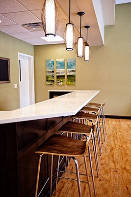 a kitchen with a counter top and bar stools