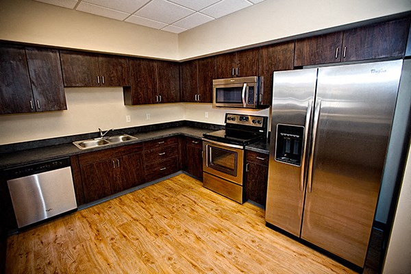 a kitchen with wooden cabinets and stainless steel appliances