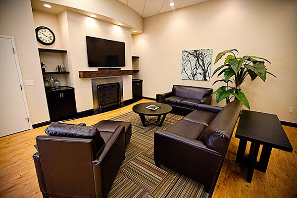 a living room with leather furniture and a fireplace