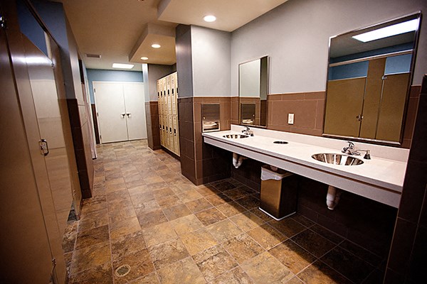 a public restroom with two sinks and two mirrors