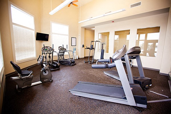 a gym with cardio equipment in an empty room