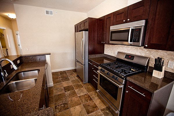 a kitchen with stainless steel appliances and granite counter tops