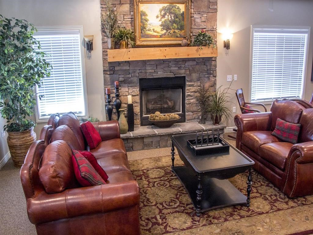 a living room with leather furniture and a fireplace