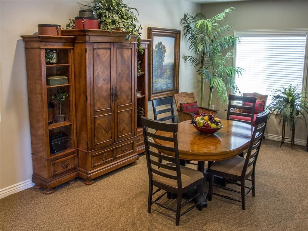 a dining room with a table and chairs