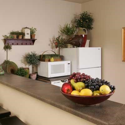 a bowl of fruit on a counter in a kitchen