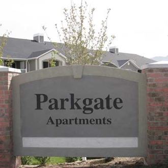 a parkgate apartments sign in front of a house