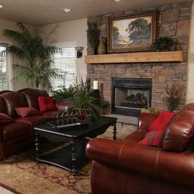 a living room with leather furniture and a fireplace