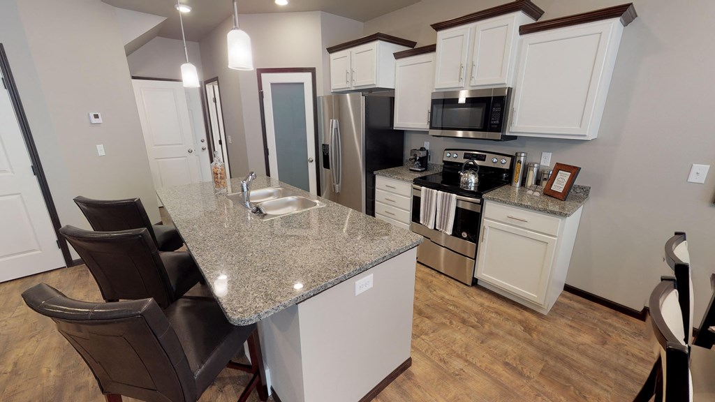 a kitchen with a granite counter top and a sink