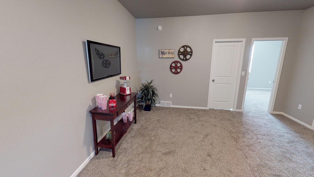 an empty living room with a table and a door