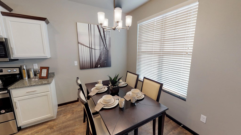 a dining room and kitchen with a table and chairs