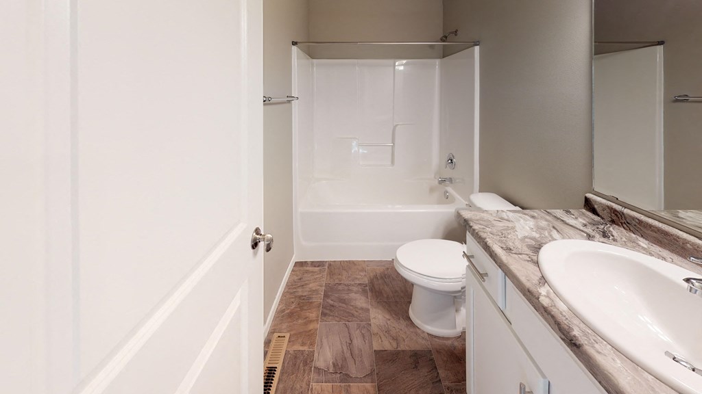 a bathroom with a toilet and a sink and a shower