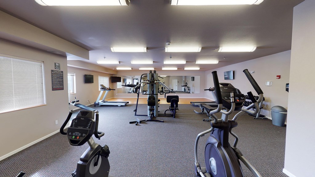 a gym with various exercise equipment in a building