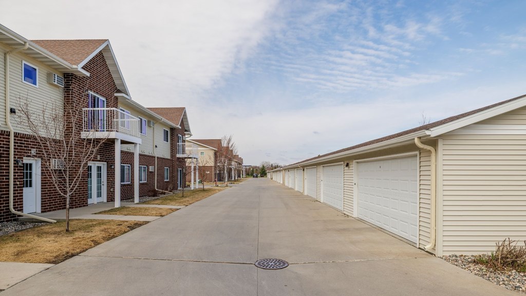 A row of houses with a driveway in the foreground.