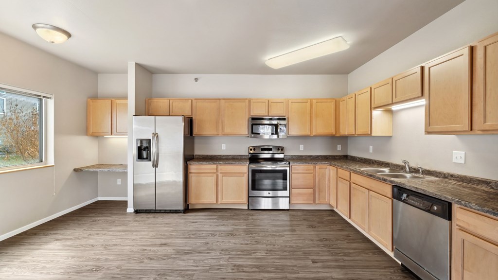 A kitchen with wooden cabinets and stainless steel appliances.