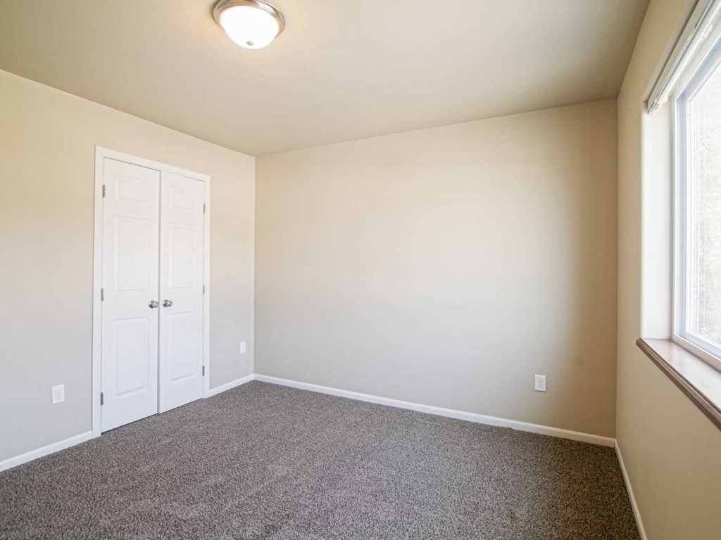 an empty room with carpet and a door