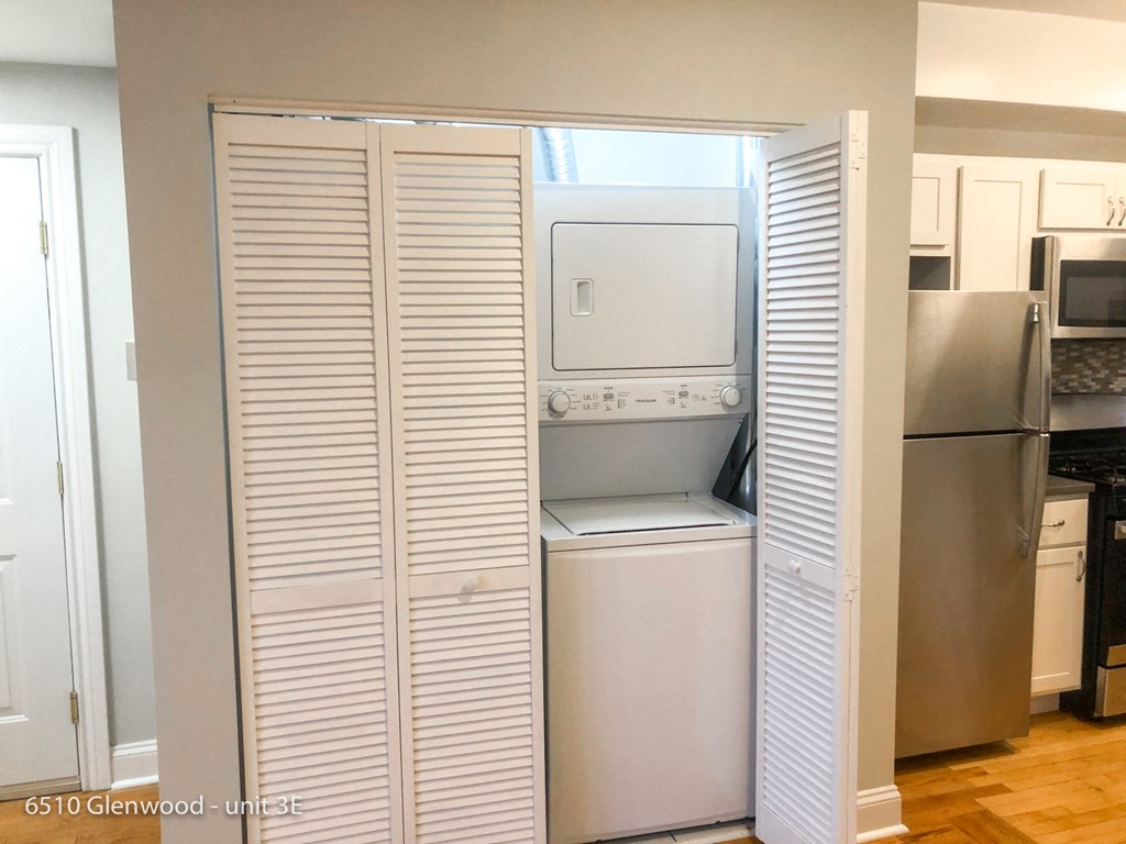 a closet with a washer and dryer in a kitchen